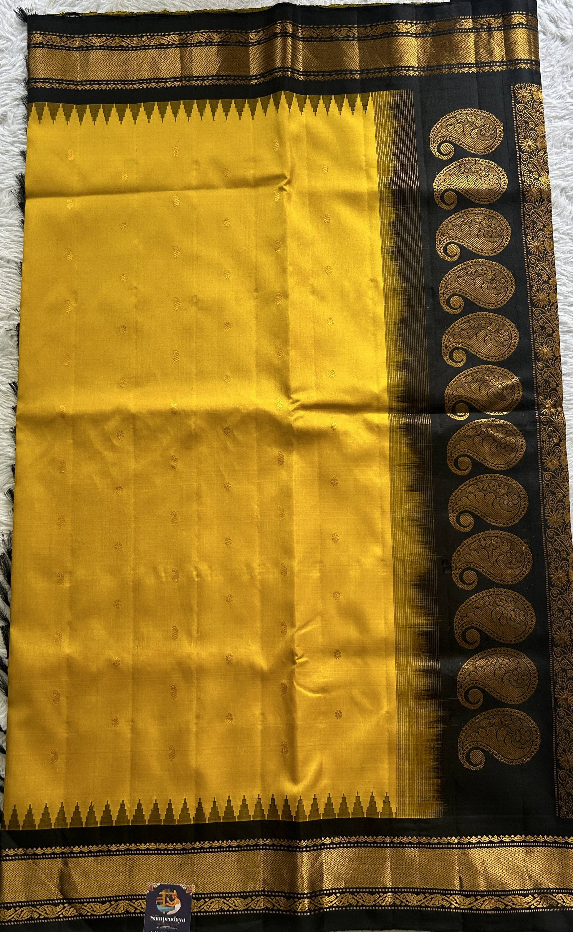 Gadwal Pattu Saree Turmeric Yellow Colored Complemented With a Zari Border - Sampradaya Designer Studio