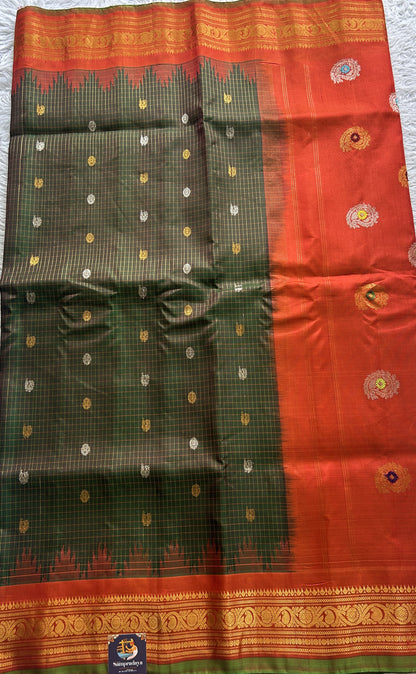 Gadwal Pattu Saree Bottle Green Colored Complemented With a Zari Border - Sampradaya Designer Studio