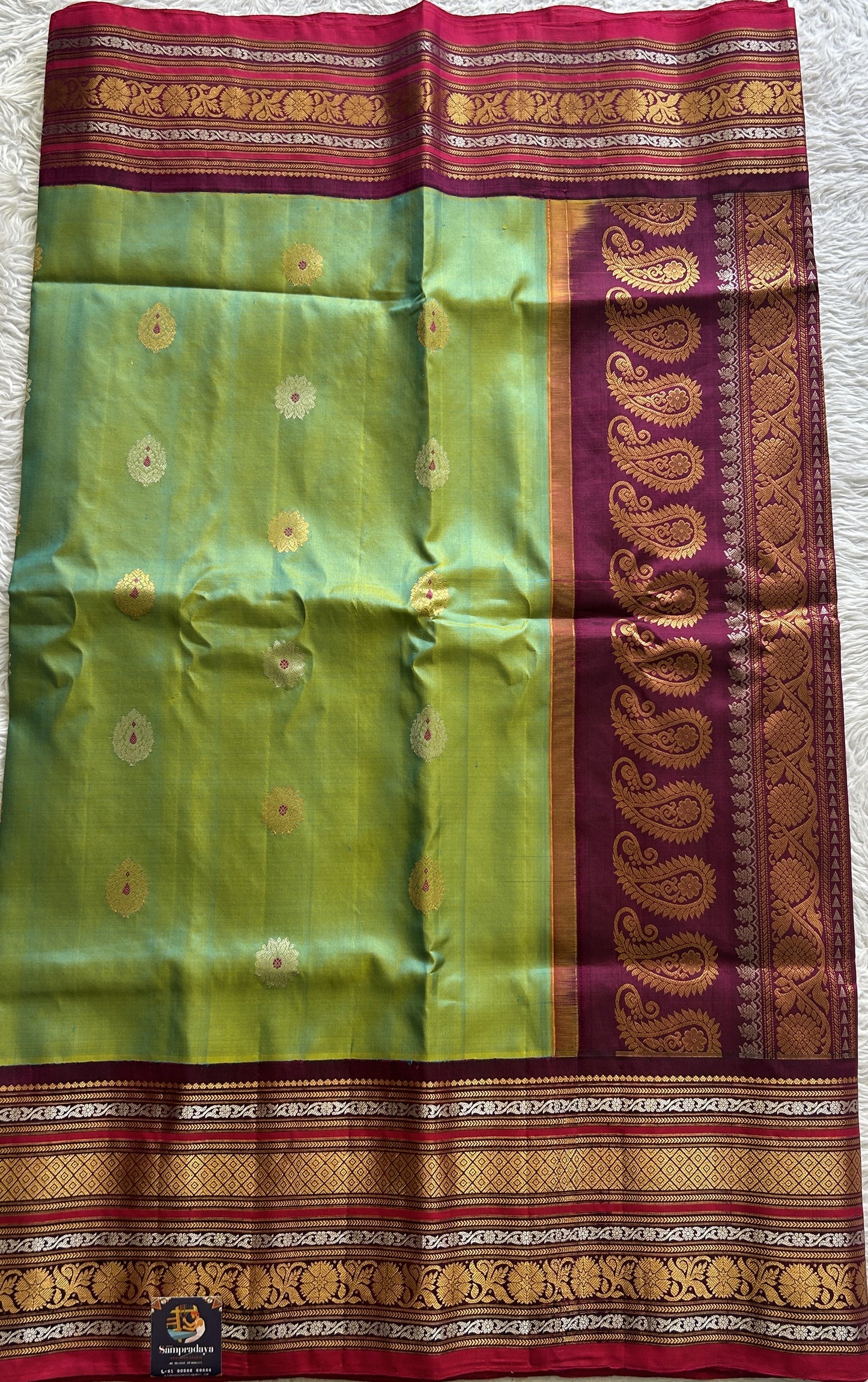 Gadwal Pattu Saree Green Colored Complemented With a Dark Pink Color Zari Border - Sampradaya Designer Studio