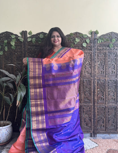 Gadwal Pattu Saree Peach colored saree complemented with a Purple Zari border