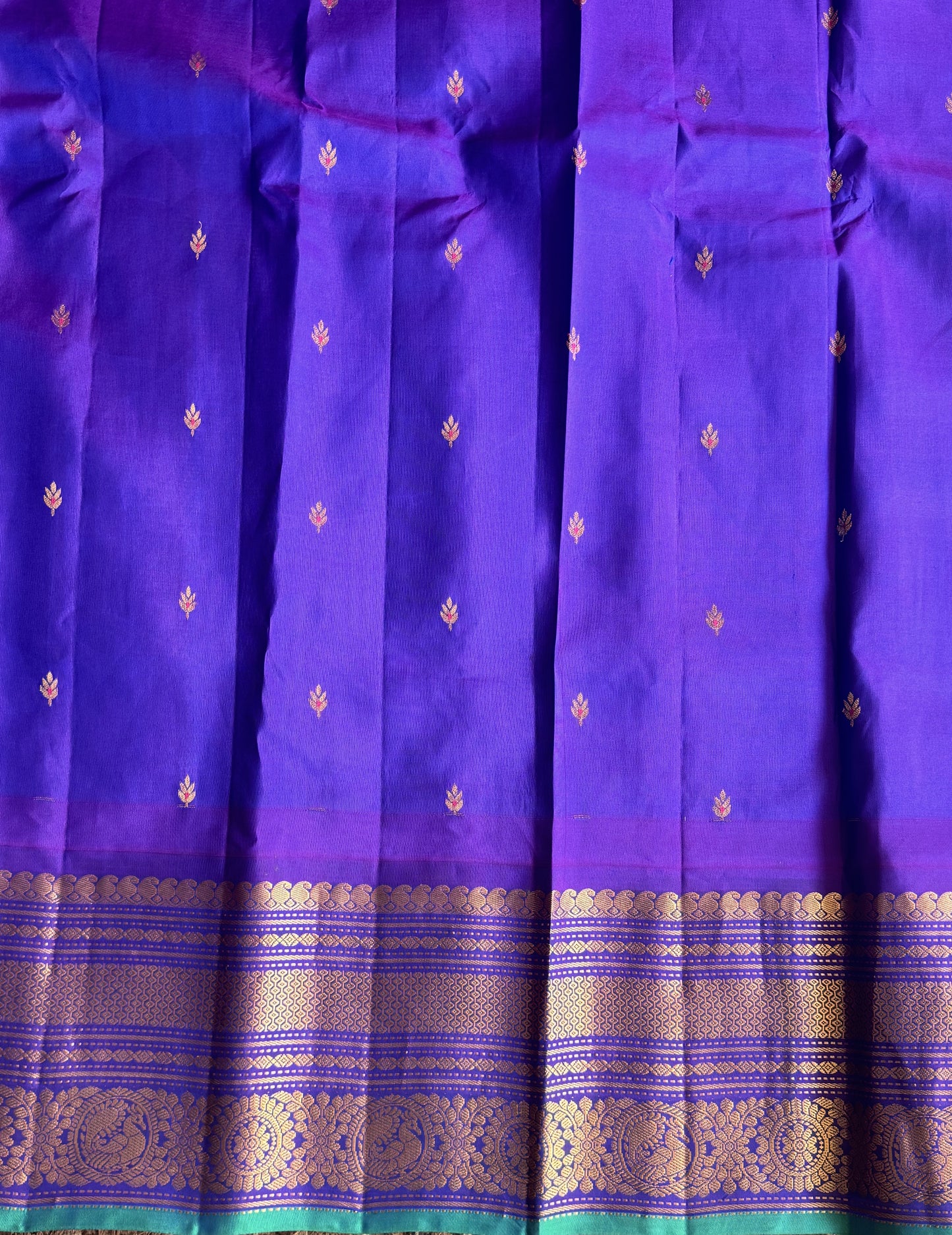 Gadwal Pattu Saree Peach colored saree complemented with a Purple Zari border