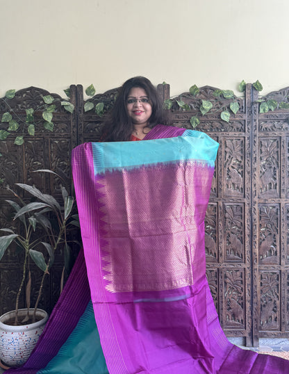 Gadwal Pattu Saree Light Turquoise Blue colored saree complemented with a Purple Checks border