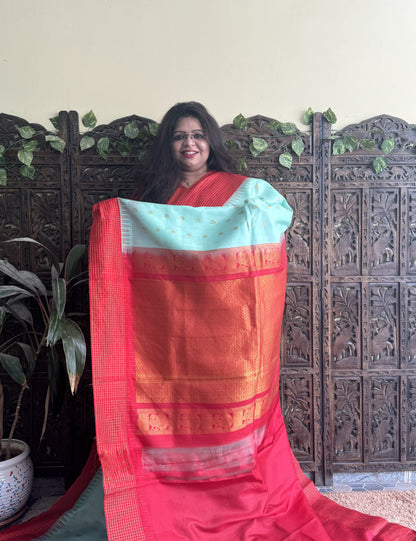 Gadwal Pattu Saree Sea Green colored saree complemented with a Red Checks border