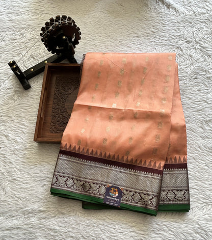 Gadwal Silk Saree Peach Colored complemented with a Brown Color Zari Border. - Sampradaya Designer Studio