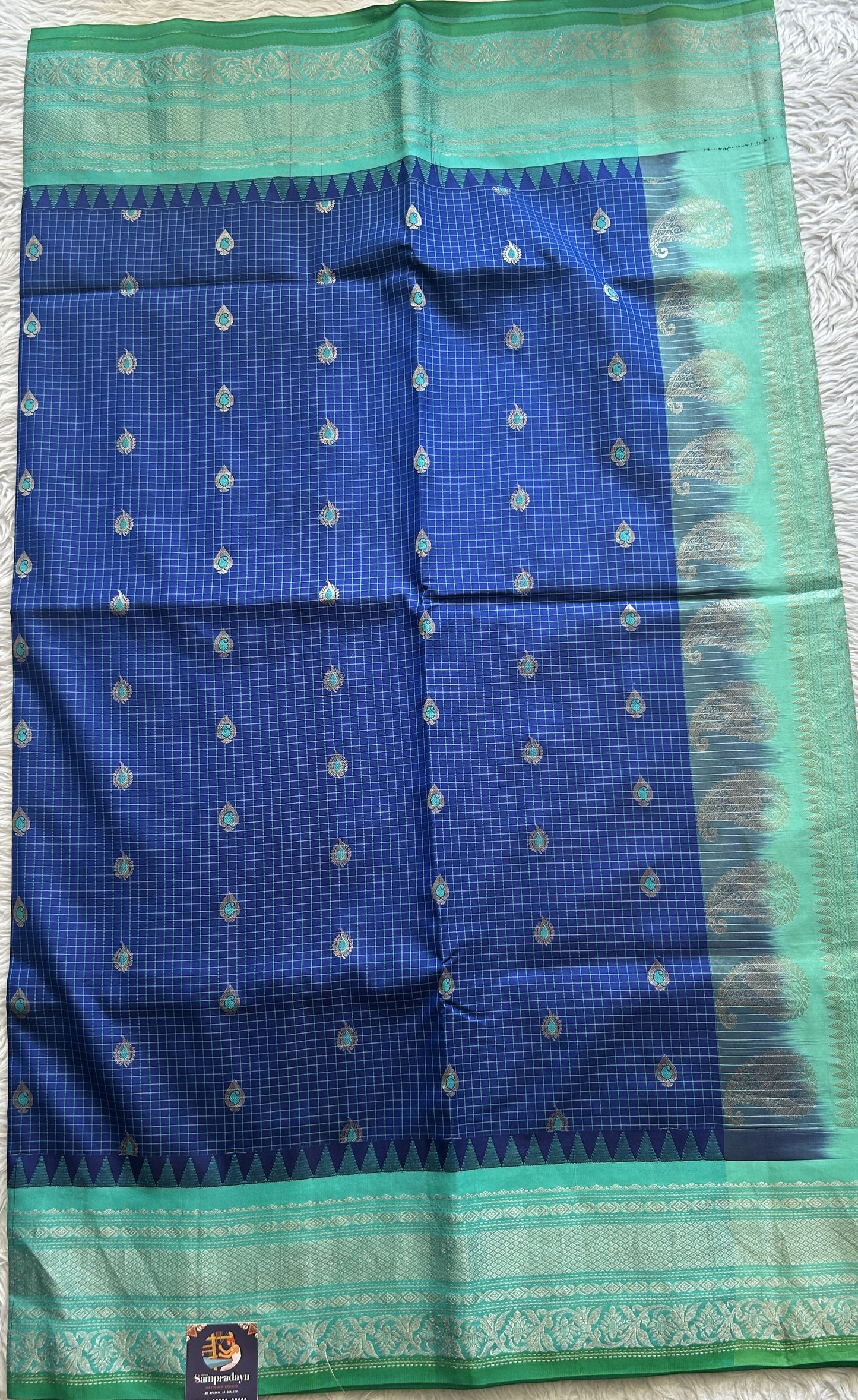 Gadwal Silk Saree Ink Blue Colored complemented with a Turquoise Blue Color Zari Border. - Sampradaya Designer Studio