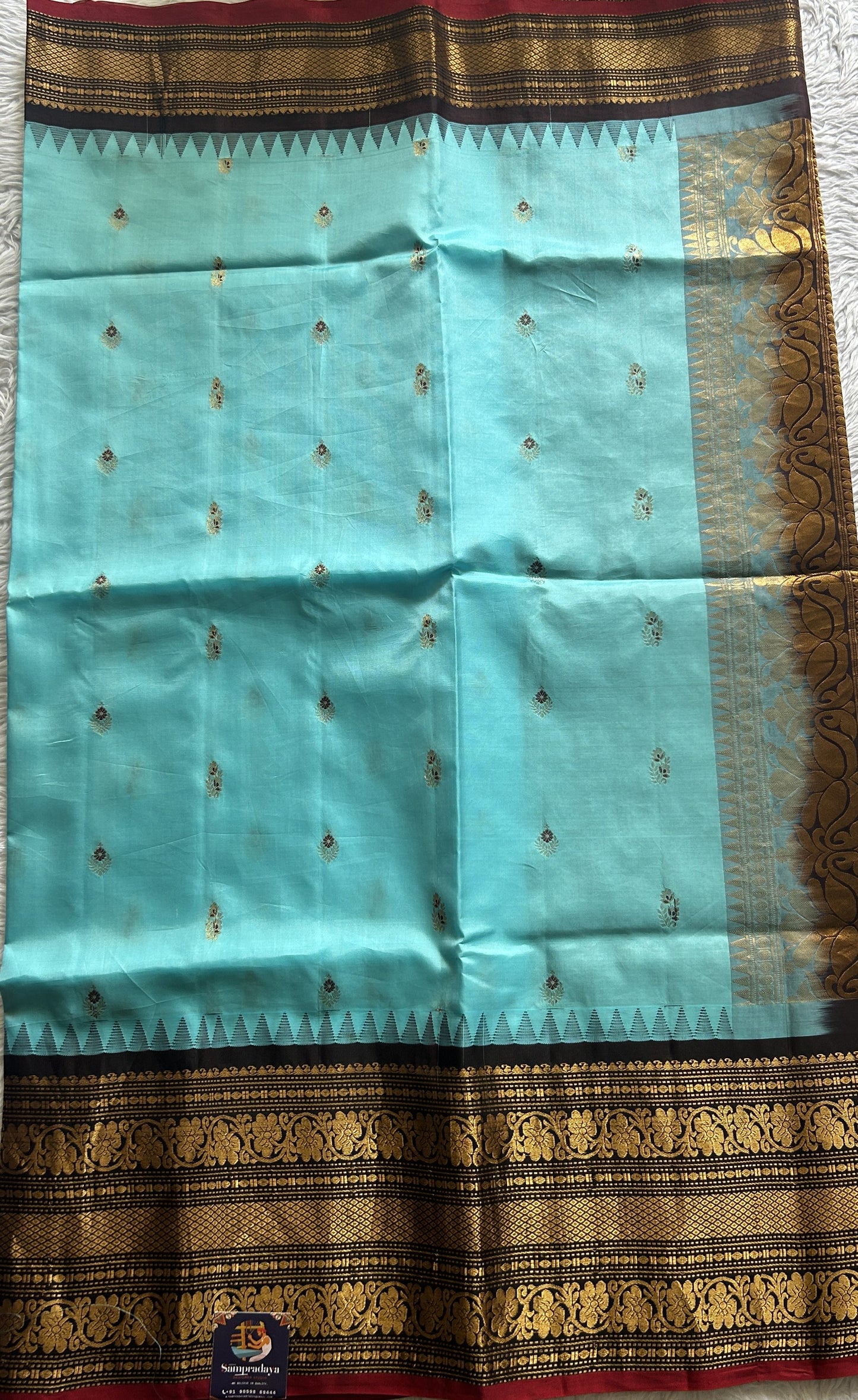 Gadwal Silk Saree Sky Blue Colored complemented with a Brown Color Zari Border. - Sampradaya Designer Studio