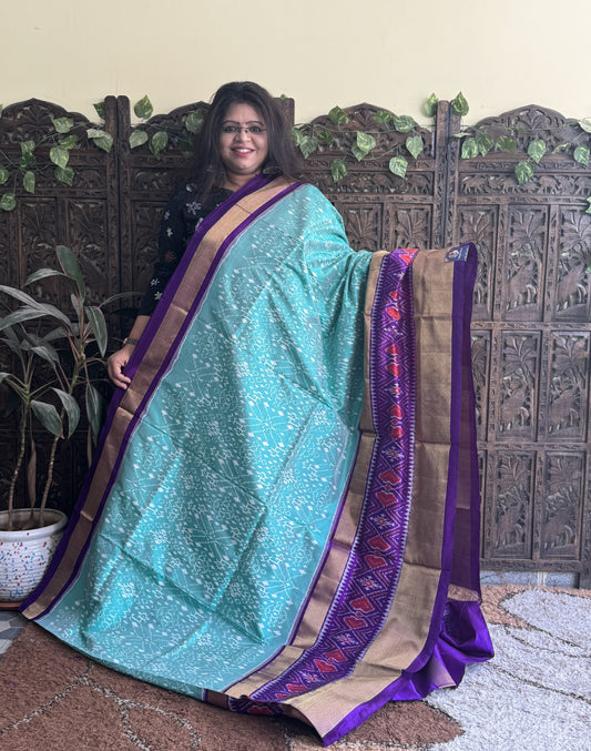 Ikkat Pattu Saree Sea Green colored complemented with a Violet Kanchi border.