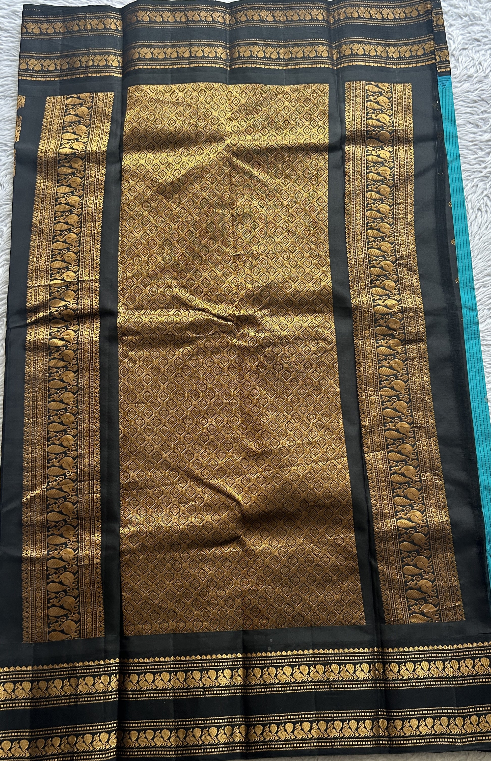 Gadwal Silk Saree Turquoise Blue Colored complemented with a Black Color Zari Border. - Sampradaya Designer Studio