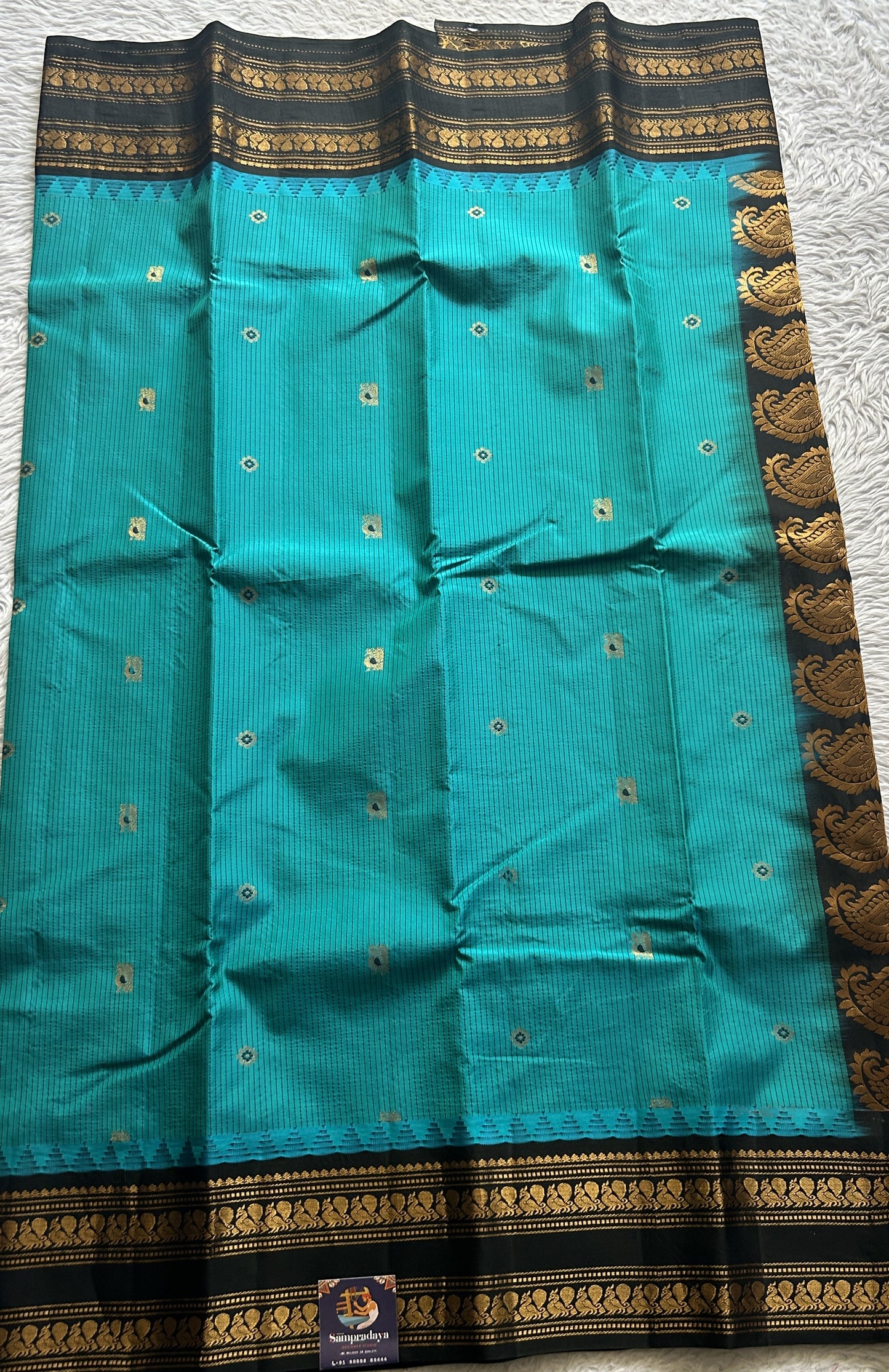 Gadwal Silk Saree Turquoise Blue Colored complemented with a Black Color Zari Border. - Sampradaya Designer Studio