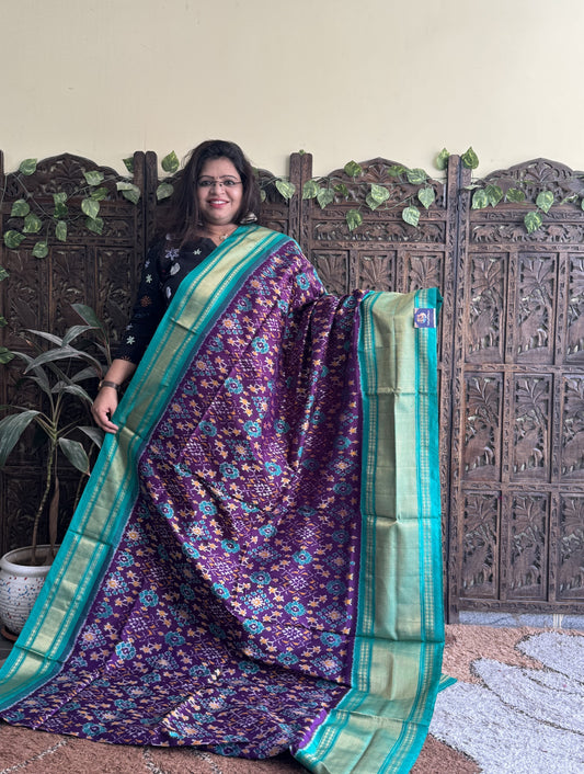 Ikkat Pattu Saree Purple colored complemented with a Sea Green Kanchi border.