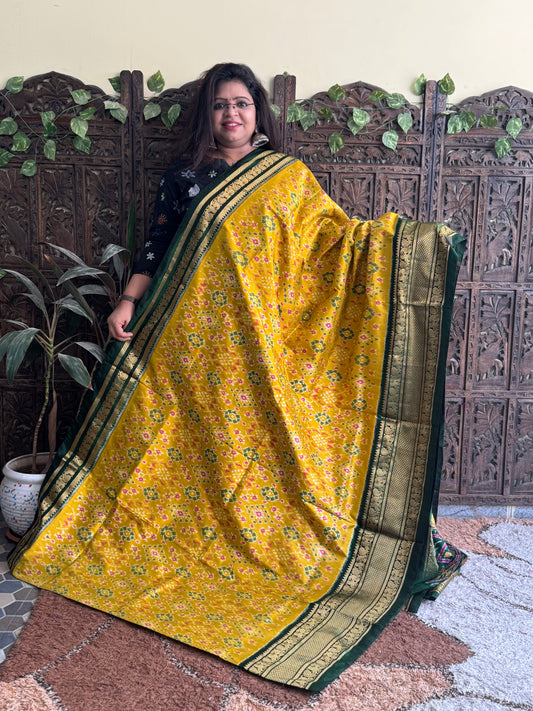 Ikkat Pattu Saree Yellow colored complemented with a Kanchi border.