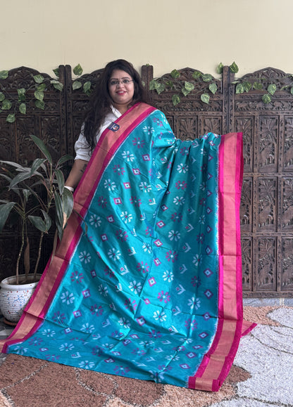 Ikkat Pattu Saree Turquoise colored complemented with a Zari border.