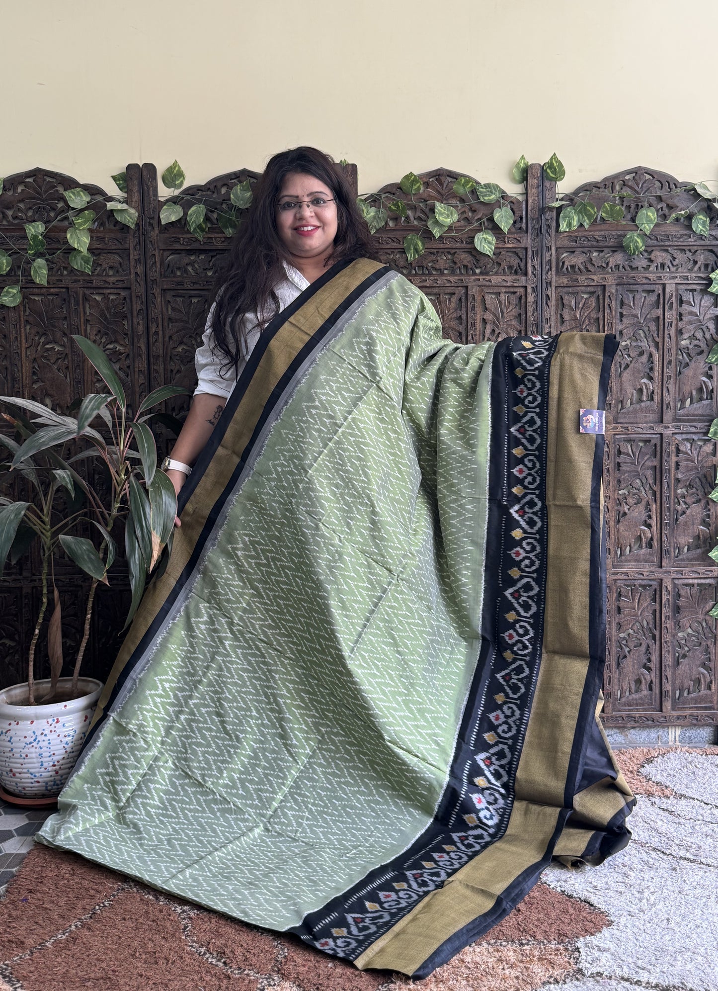 Ikkat Pattu Saree Olive Green colored complemented with a Ikkat Zari border.