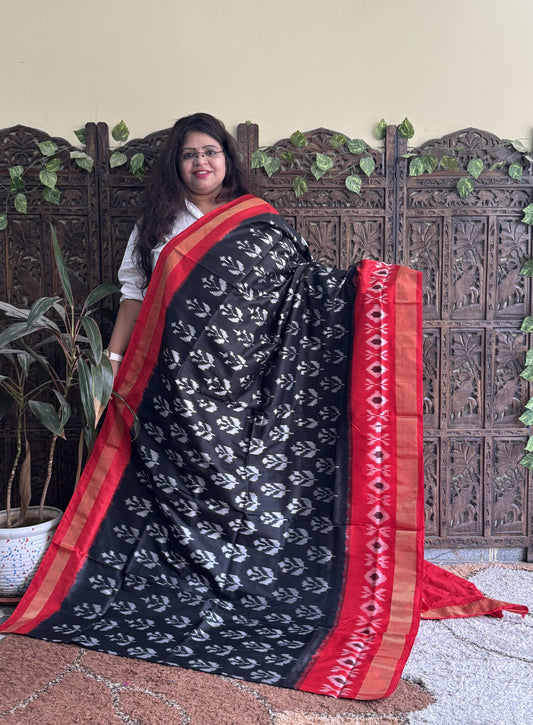 Ikkat Pattu Saree Black colored complemented with a Ikkat Zari border.