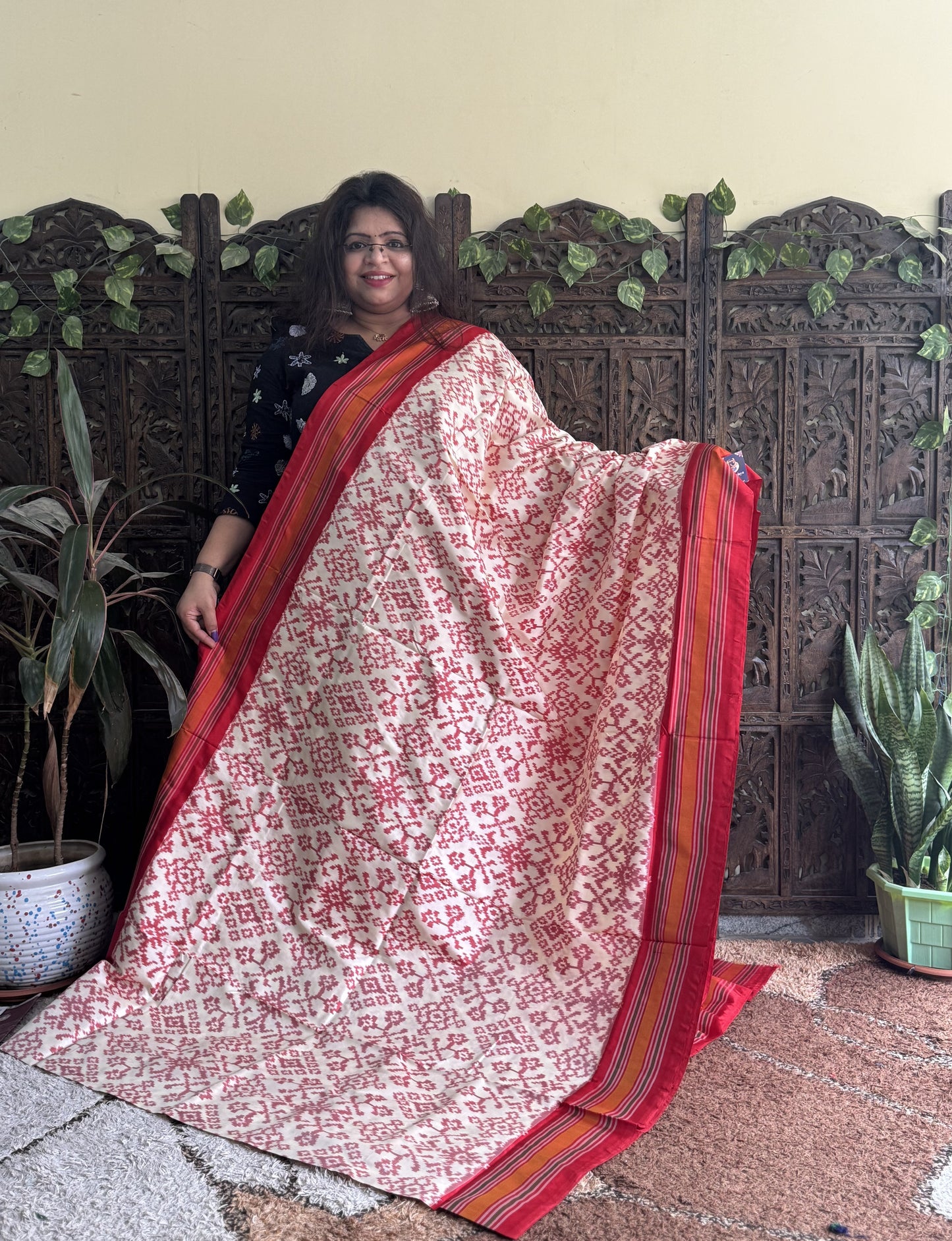 Ikkat Pattu Saree Cream colored complemented with a Red Patola border.