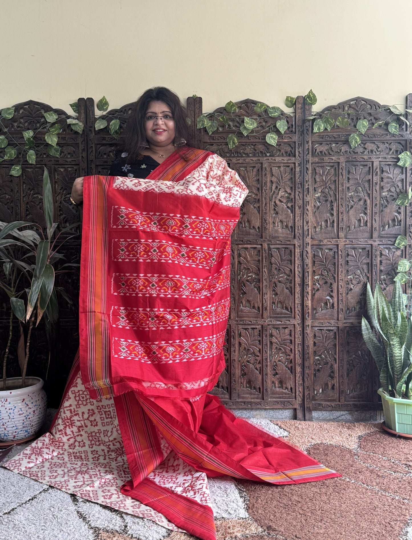 Ikkat Pattu Saree Cream colored complemented with a Red Patola border.