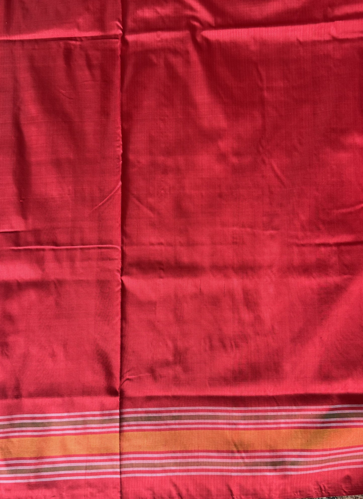 Ikkat Pattu Saree Cream colored complemented with a Red Patola border.