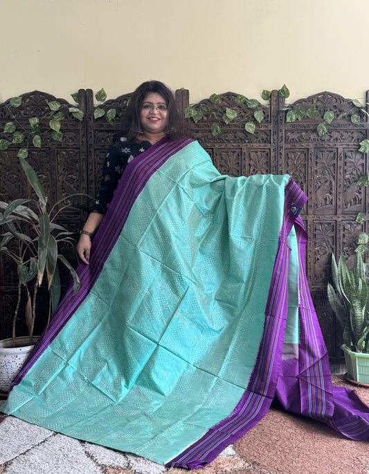 Ikkat Pattu Saree Sea Green colored complemented with a Patola border.