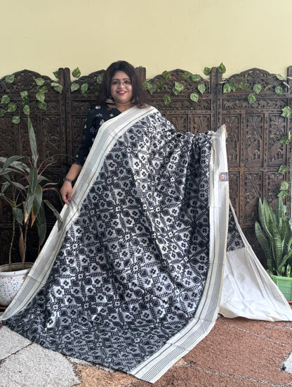 Ikkat Pattu Saree Gray colored complemented with a Patola border.