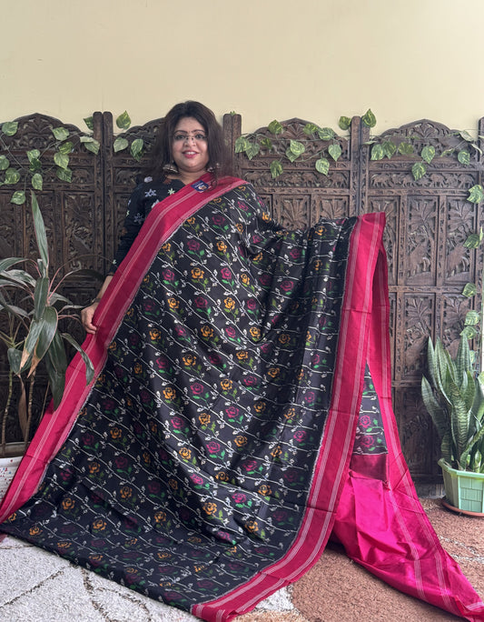 Ikkat Pattu Saree Black colored complemented with a Patola border.