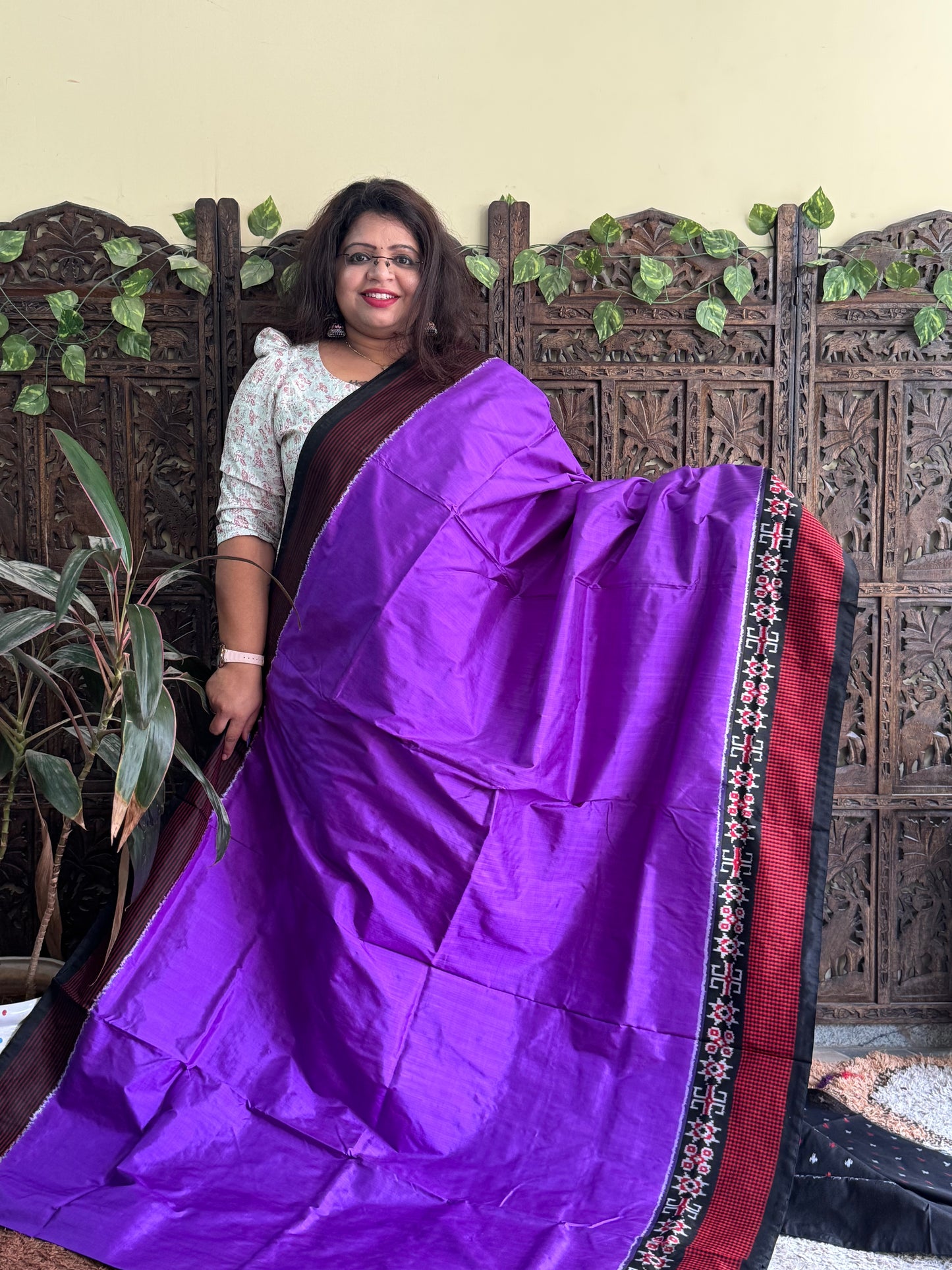 Ikkat Pattu Saree Purple colored complemented with a Checks border.