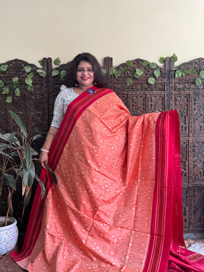 Ikkat Pattu Saree Light Orange colored complemented with a Patalo border.