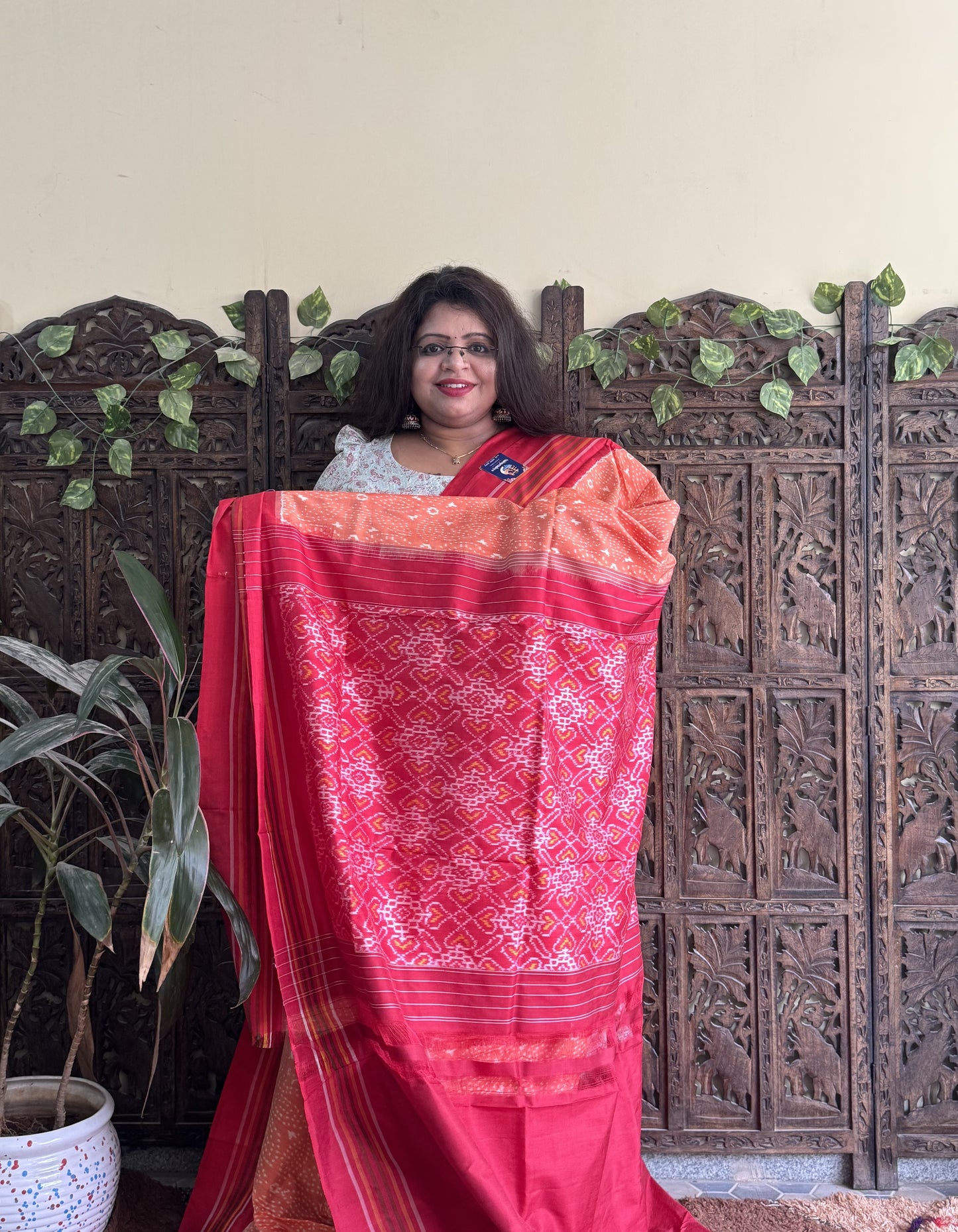 Ikkat Pattu Saree Light Orange colored complemented with a Patalo border.