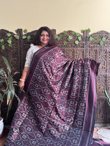 Ikkat Pattu Saree Dark Brown colored complemented with a Patalo border.