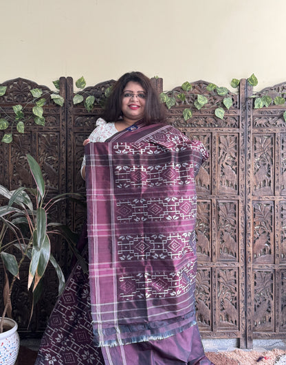 Ikkat Pattu Saree Dark Brown colored complemented with a Patalo border.