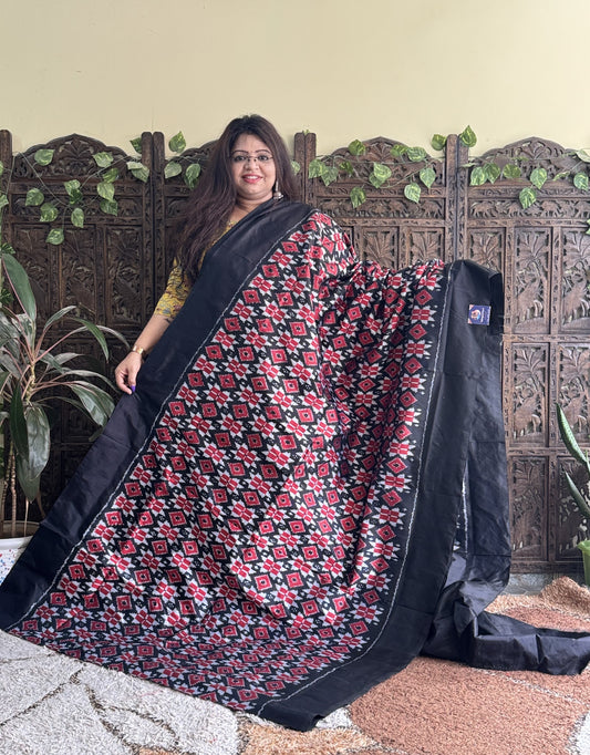 Ikkat Pattu Saree Black colored complemented with a Plain border.