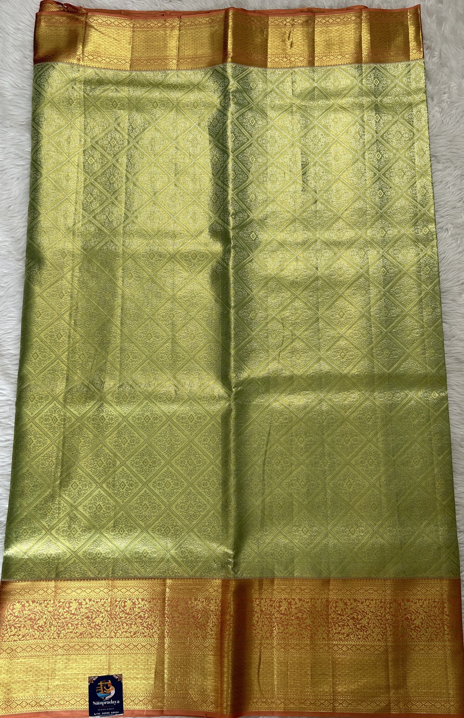 Kanjivaram Bridal Silk Saree Pastel Green colored Saree complemented with a Pastel Orange Color Gold Zari Weaving border. - Sampradaya Designer Studio