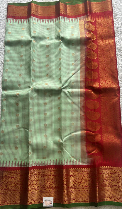 Gadwal Pattu Saree Pista Green colored saree complemented with a Zari border - Sampradaya Designer Studio