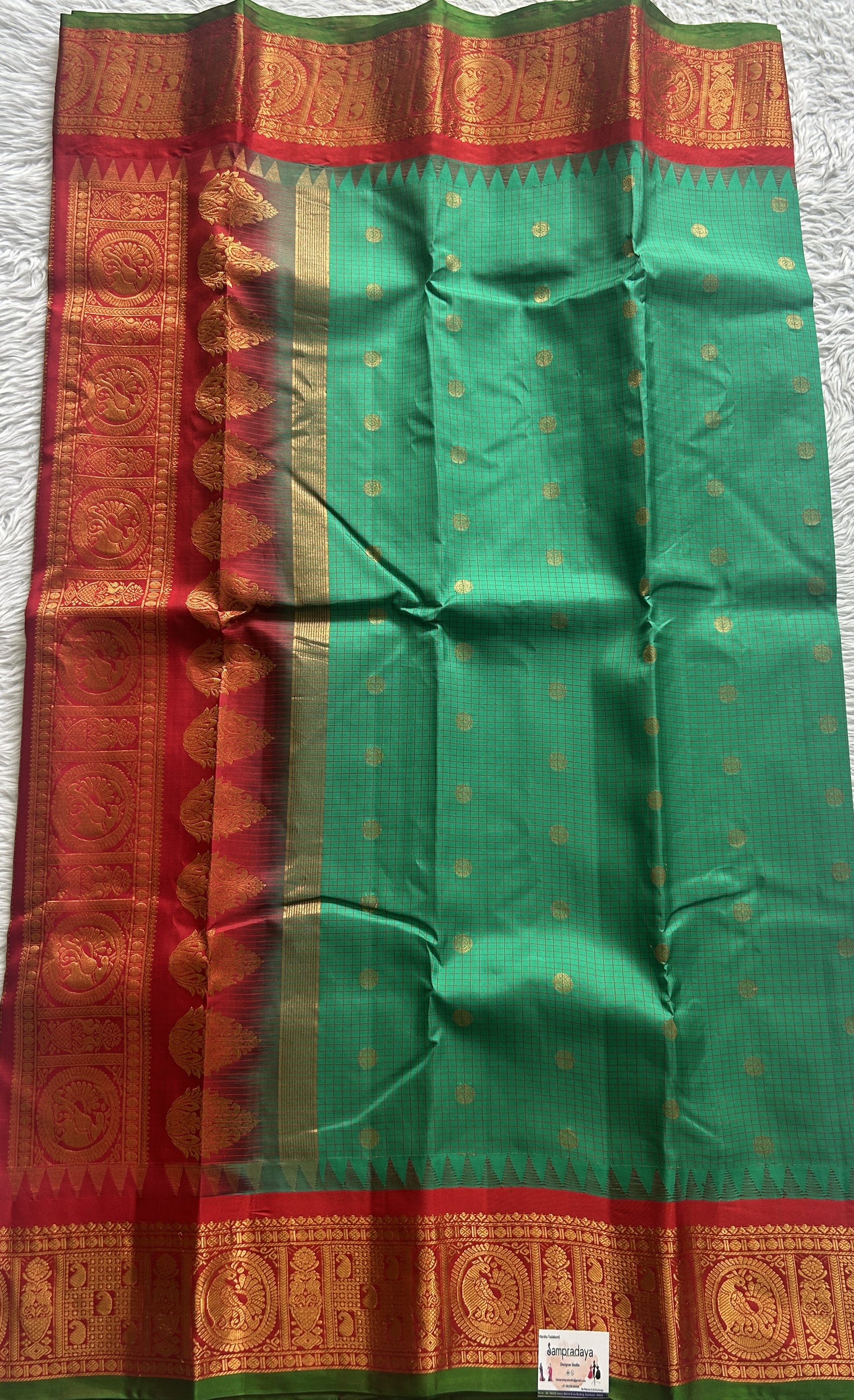 Gadwal Pattu Saree Dark Green colored saree complemented with a Zari border - Sampradaya Designer Studio