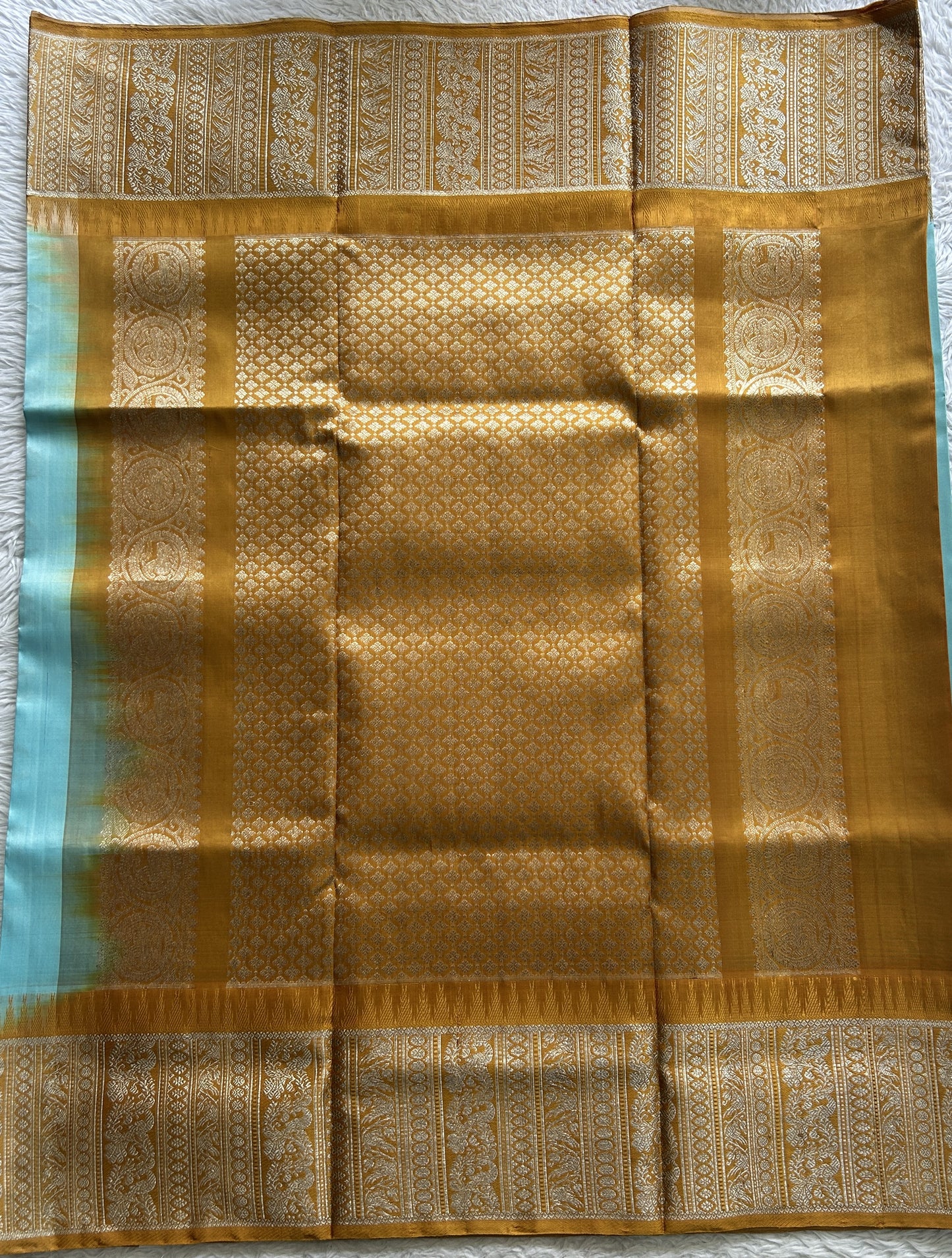 Venkatagiri Pattu Saree Sky Blue Complemented With a Mustard Color Zari Border.