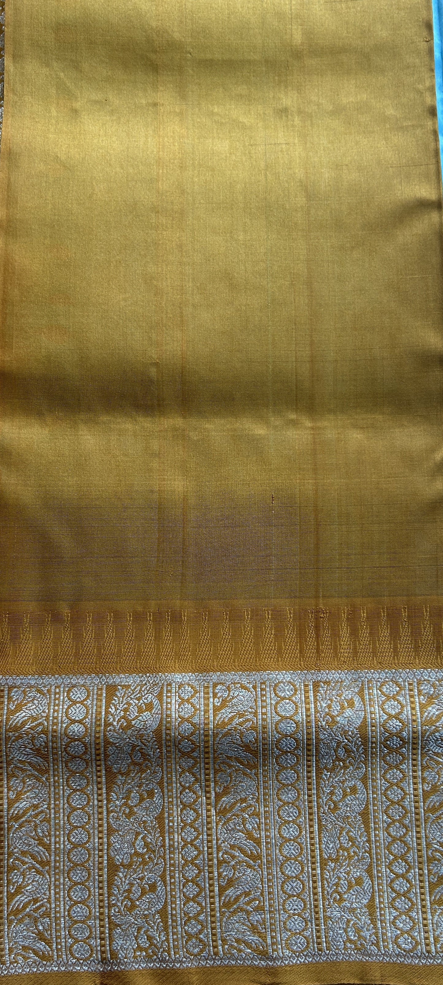 Venkatagiri Pattu Saree Sky Blue Complemented With a Mustard Color Zari Border.