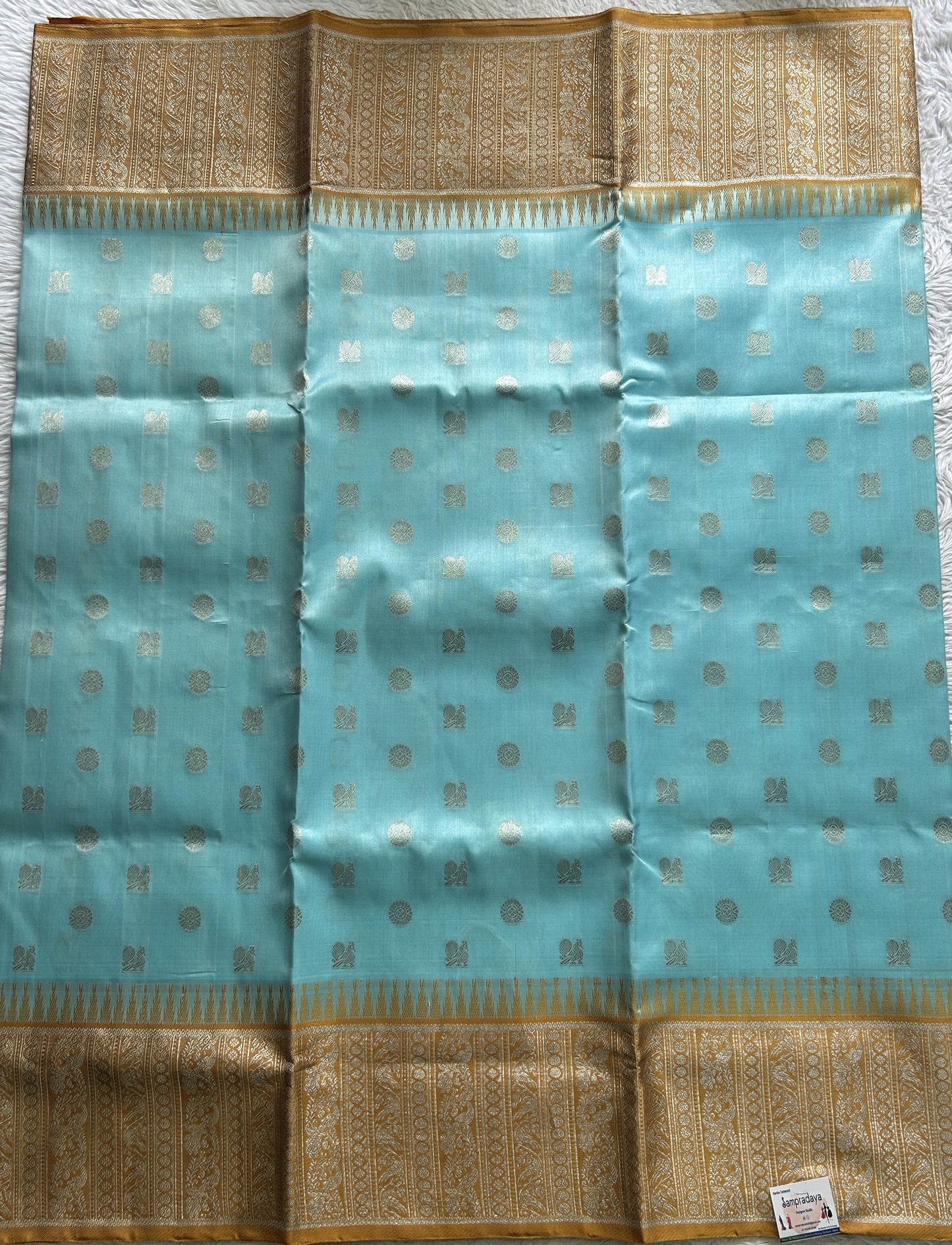 Venkatagiri Pattu Saree Sky Blue Complemented With a Mustard Color Zari Border.