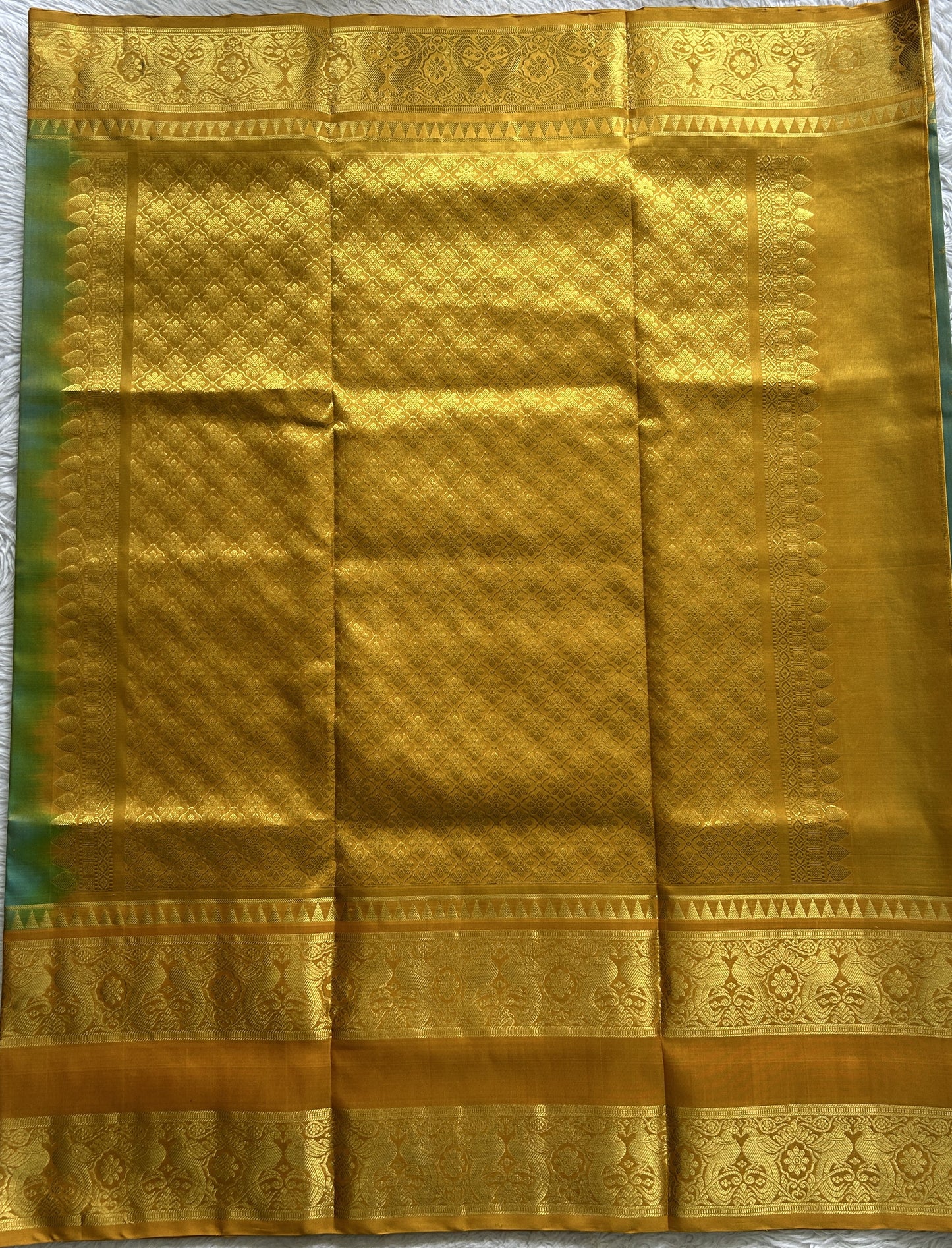 Venkatagiri Pattu Saree Sea Blue Complemented With a Mustard Color Zari Border.