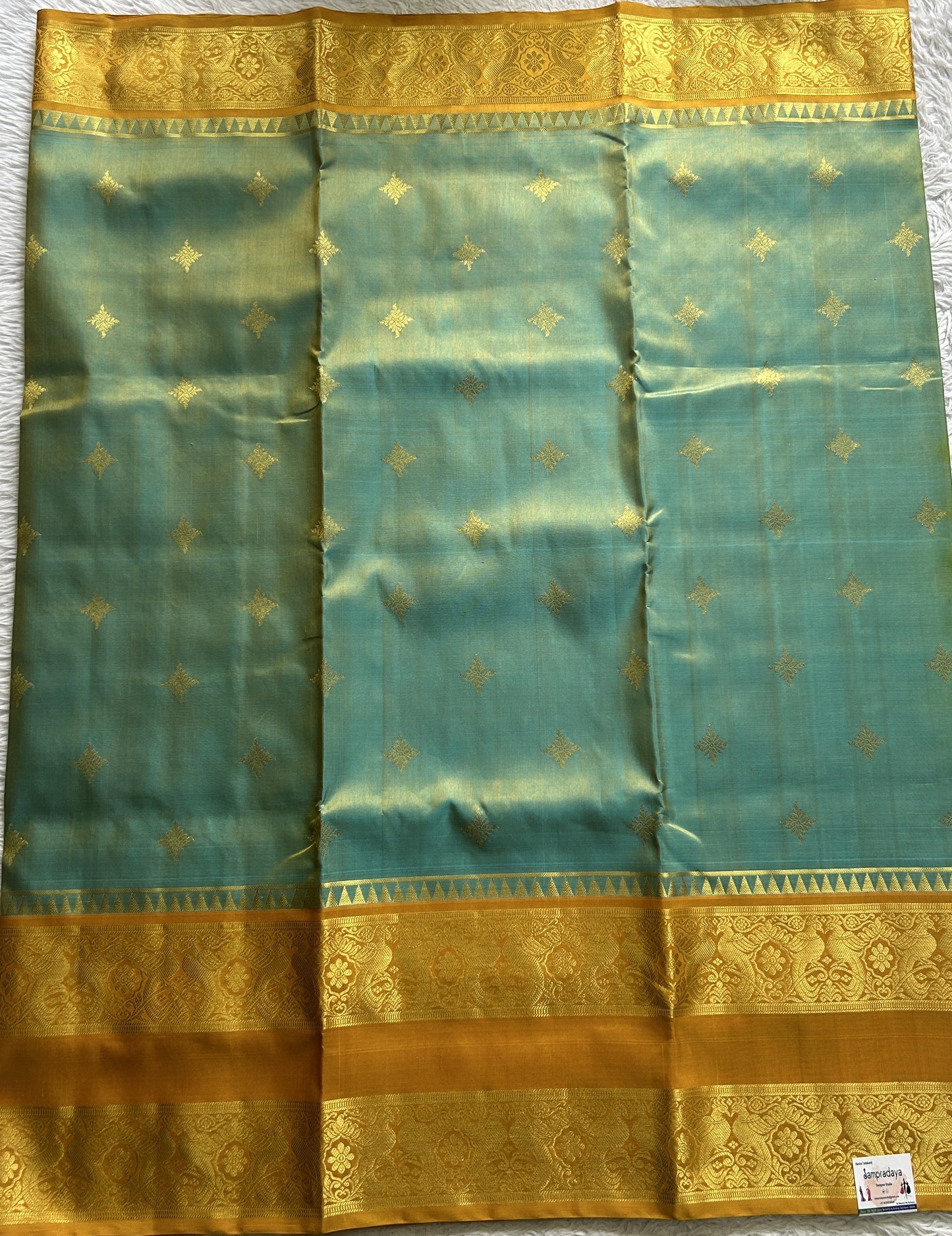 Venkatagiri Pattu Saree Sea Blue Complemented With a Mustard Color Zari Border.