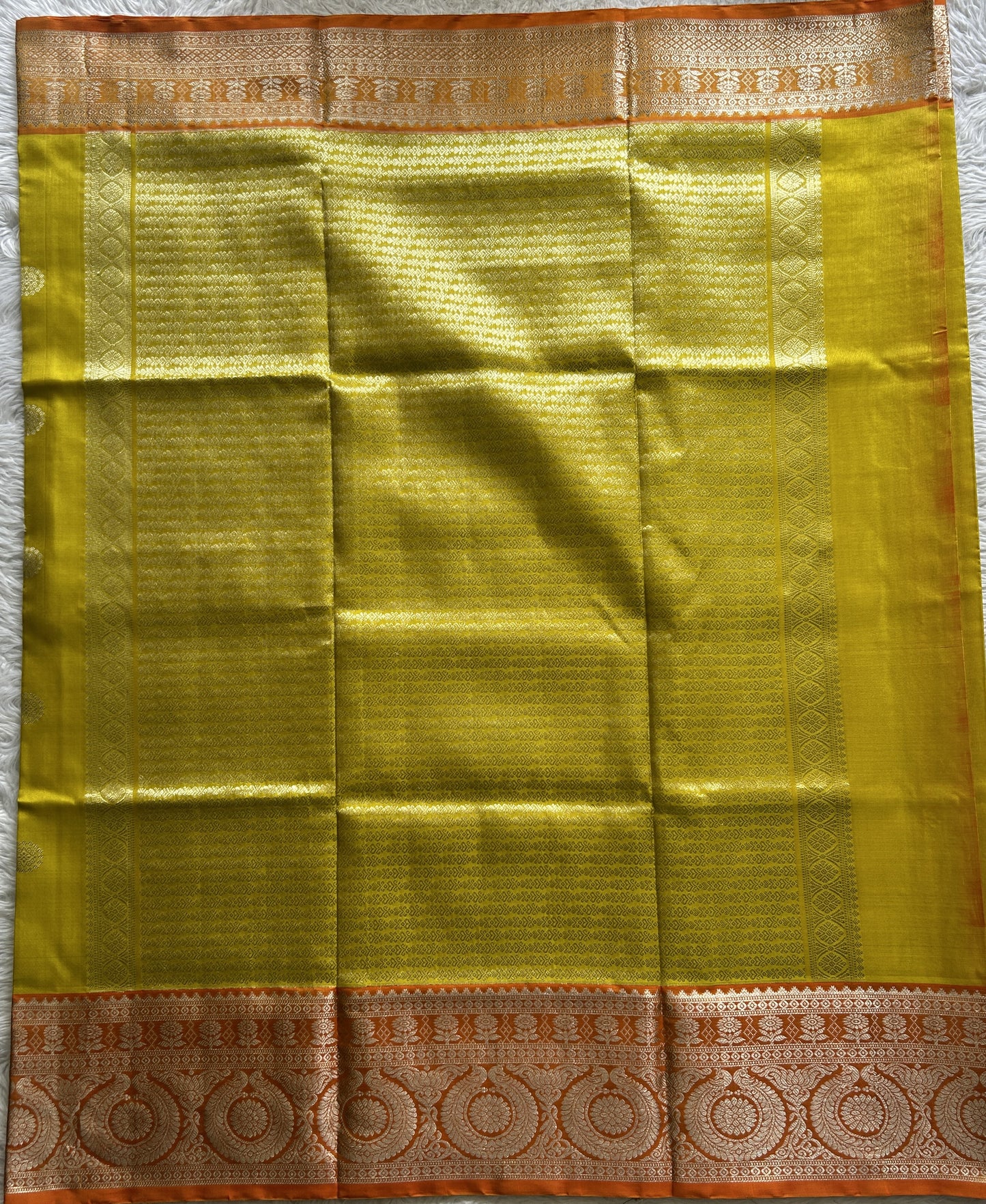 Venkatagiri Pattu Saree Yellow Colored Complemented With a Orange Color Zari Border.