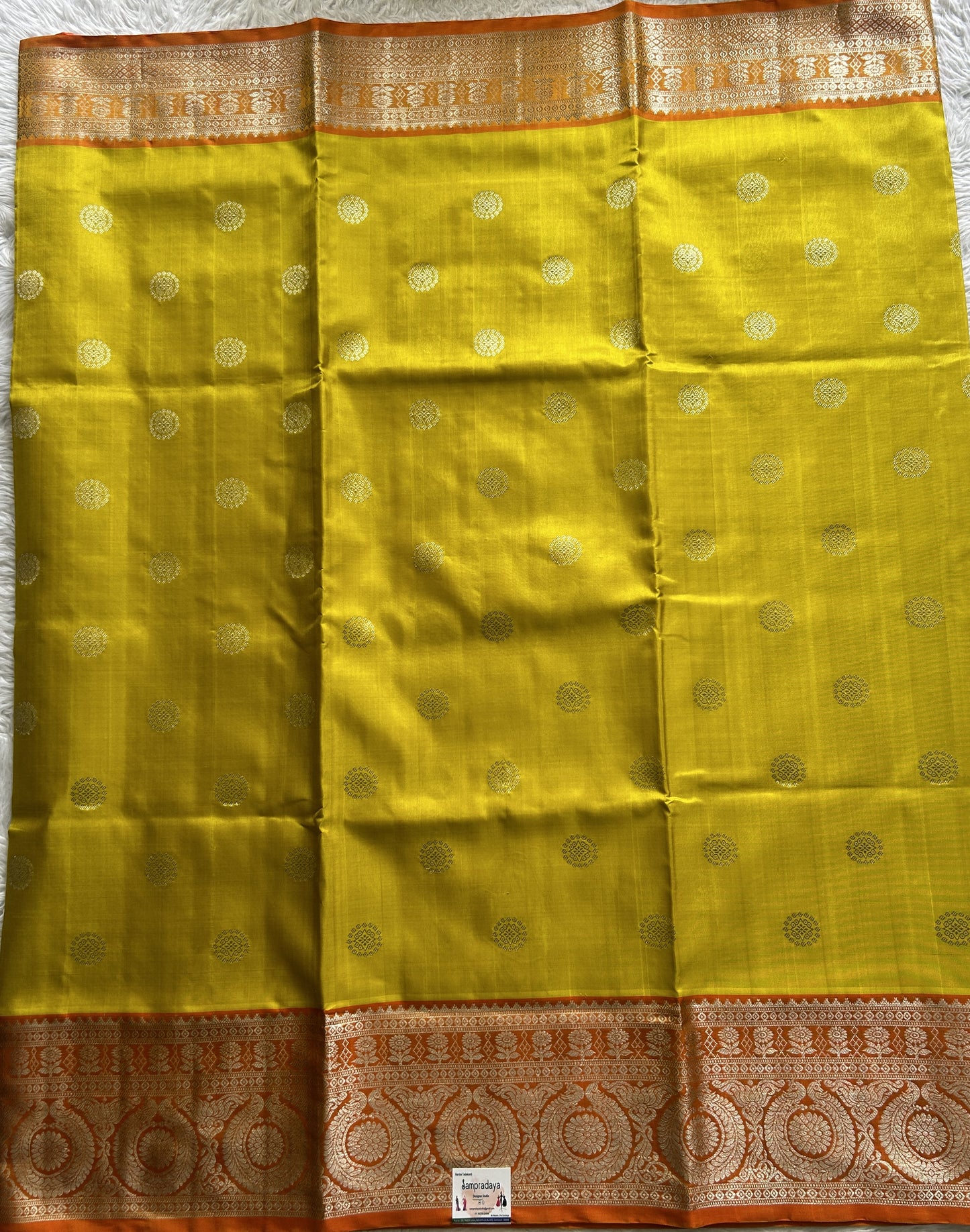 Venkatagiri Pattu Saree Yellow Colored Complemented With a Orange Color Zari Border.