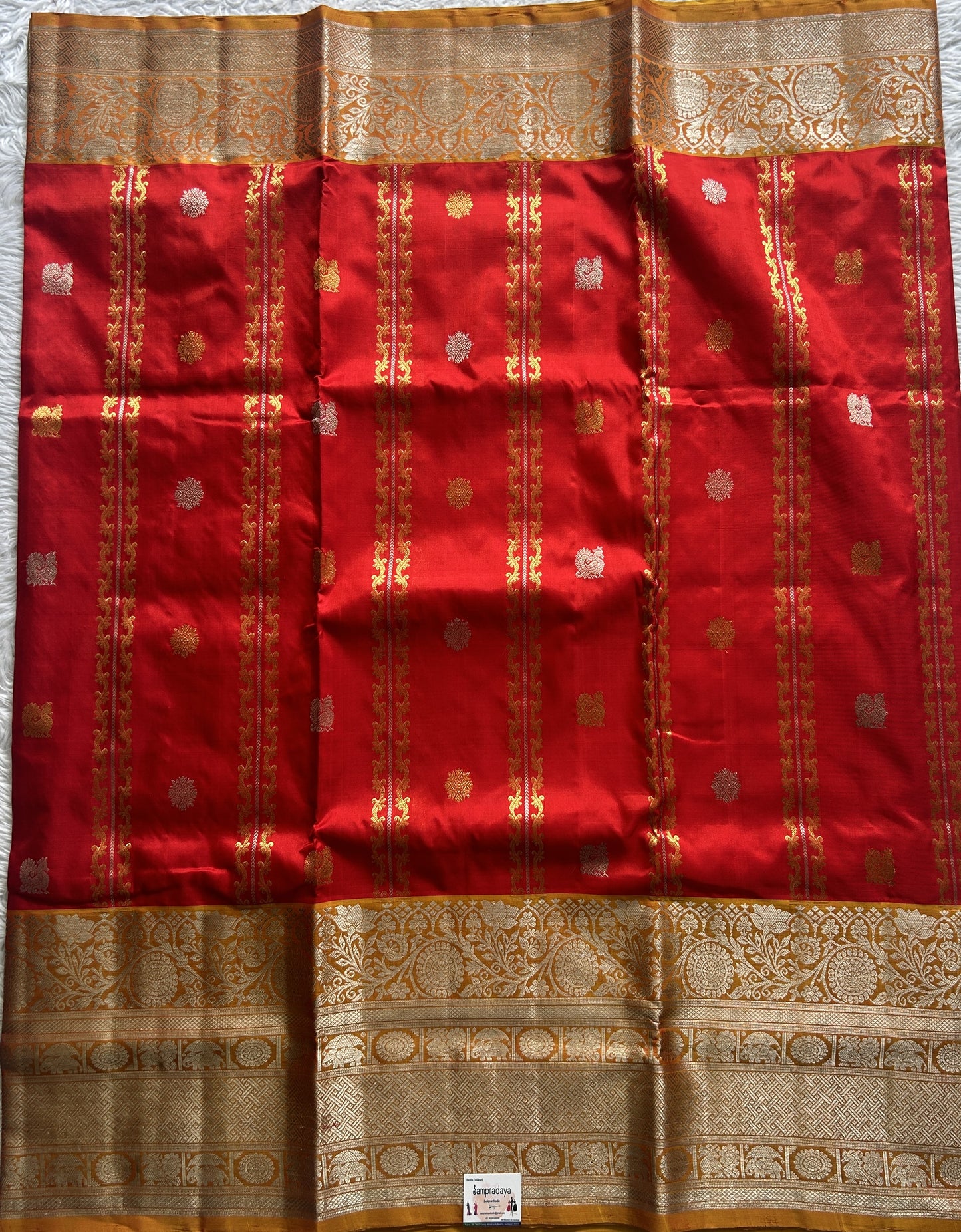 Venkatagiri Pattu Saree Red Colored Complemented With a Mustard Color Zari Border.