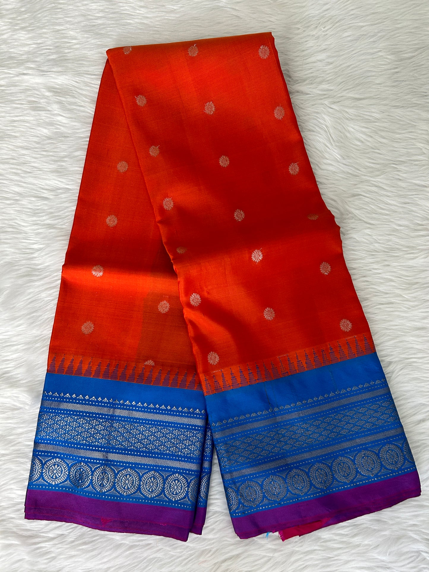 Gadwal Pattu Saree Tomato Red-colored saree complemented with a Teal Blue border - Sampradaya Designer Studio