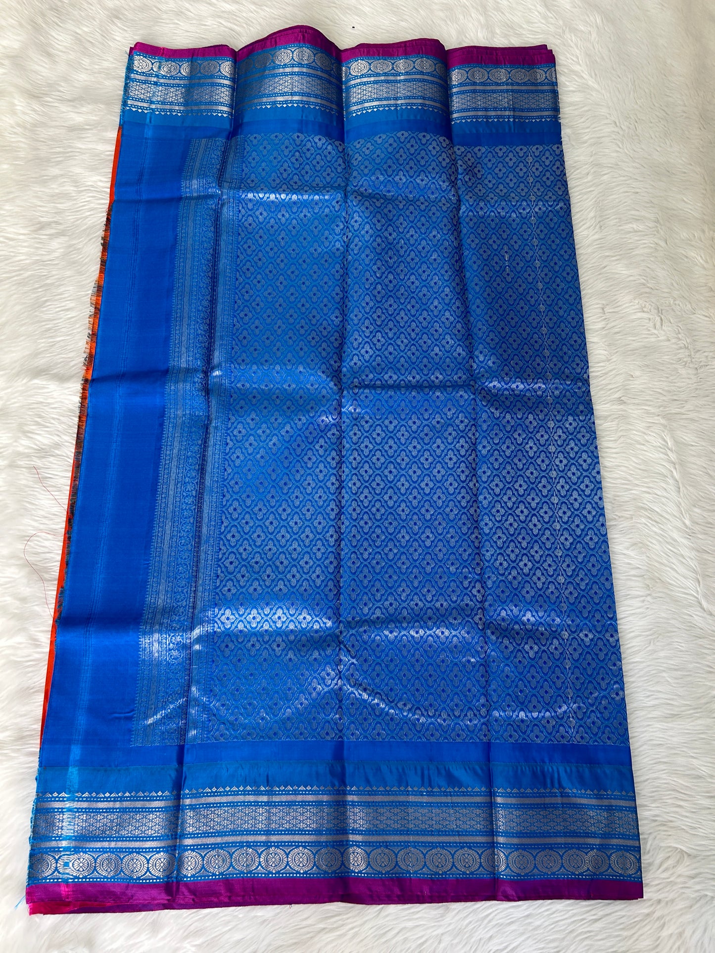 Gadwal Pattu Saree Tomato Red-colored saree complemented with a Teal Blue border - Sampradaya Designer Studio