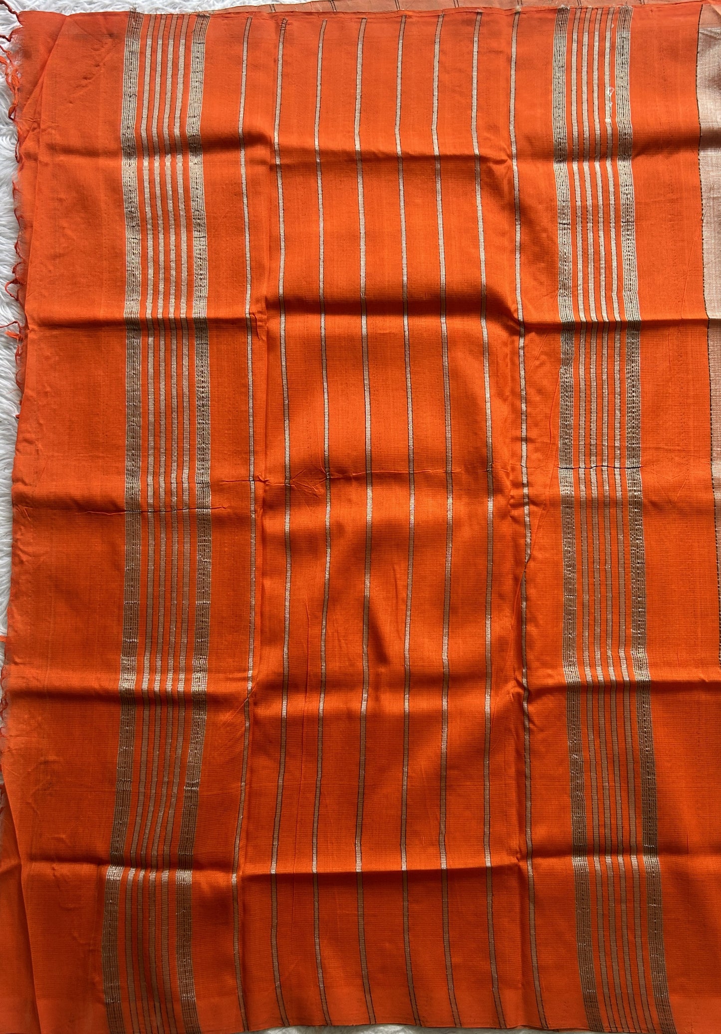 Mangalagiri Plain Pattu Saree Light Orange colored complemented with a No Border.