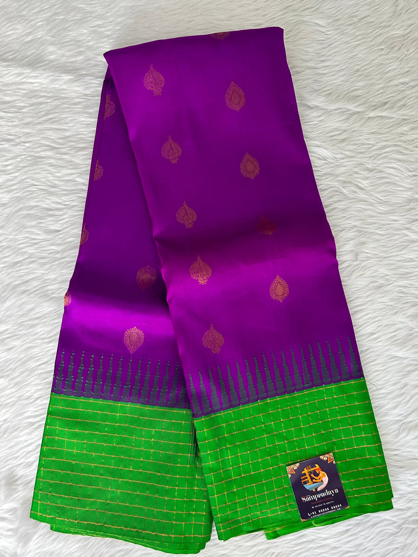 Gadwal Pattu Saree Purple-colored saree complemented with a Grass Green border - Sampradaya Designer Studio