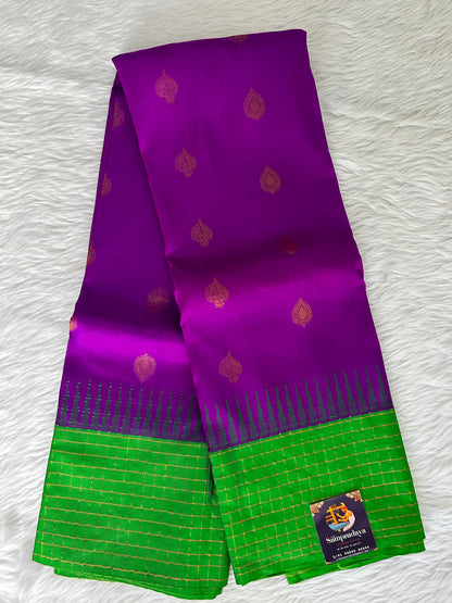 Gadwal Pattu Saree Purple-colored saree complemented with a Grass Green border - Sampradaya Designer Studio