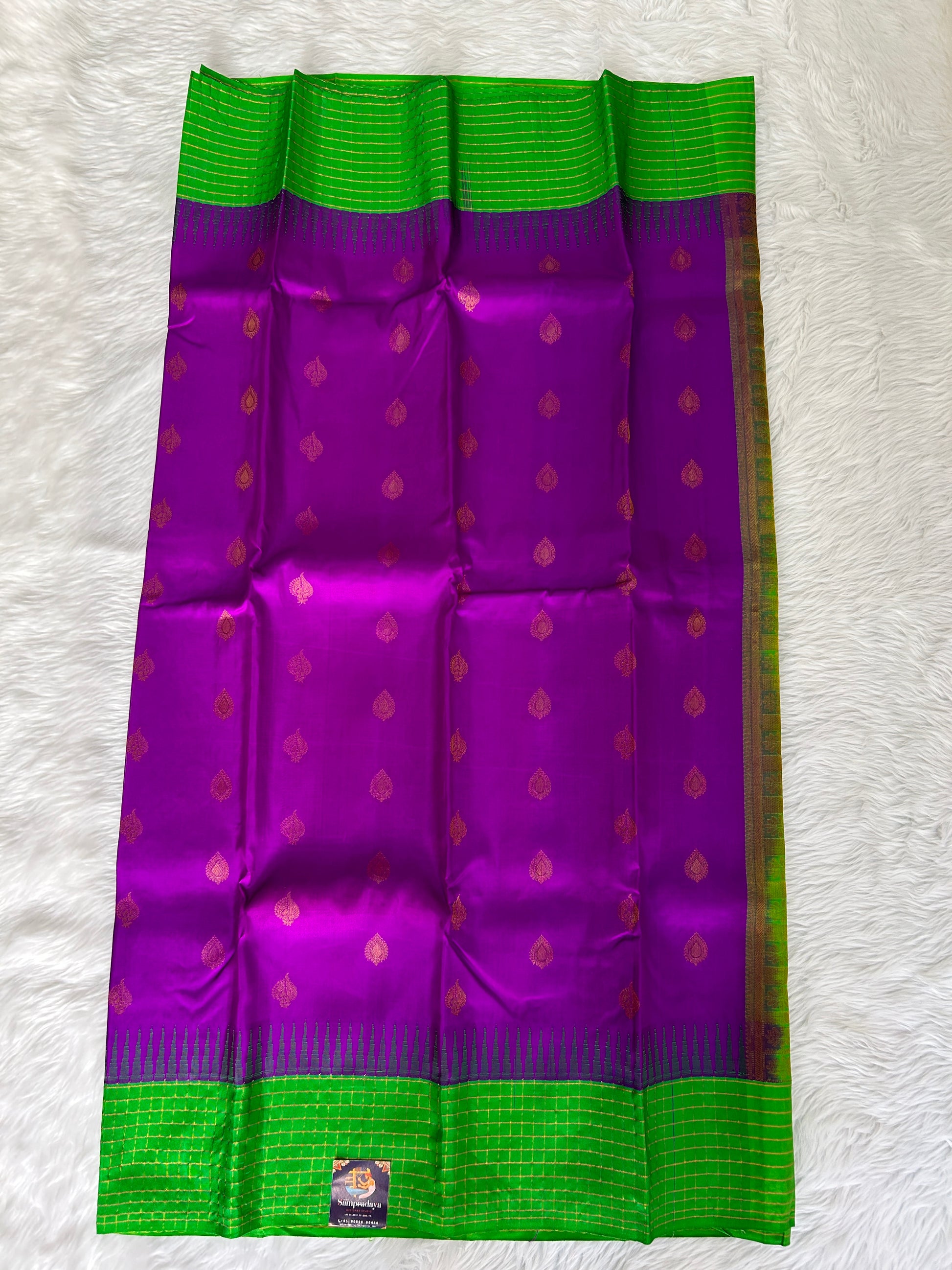 Gadwal Pattu Saree Purple-colored saree complemented with a Grass Green border - Sampradaya Designer Studio