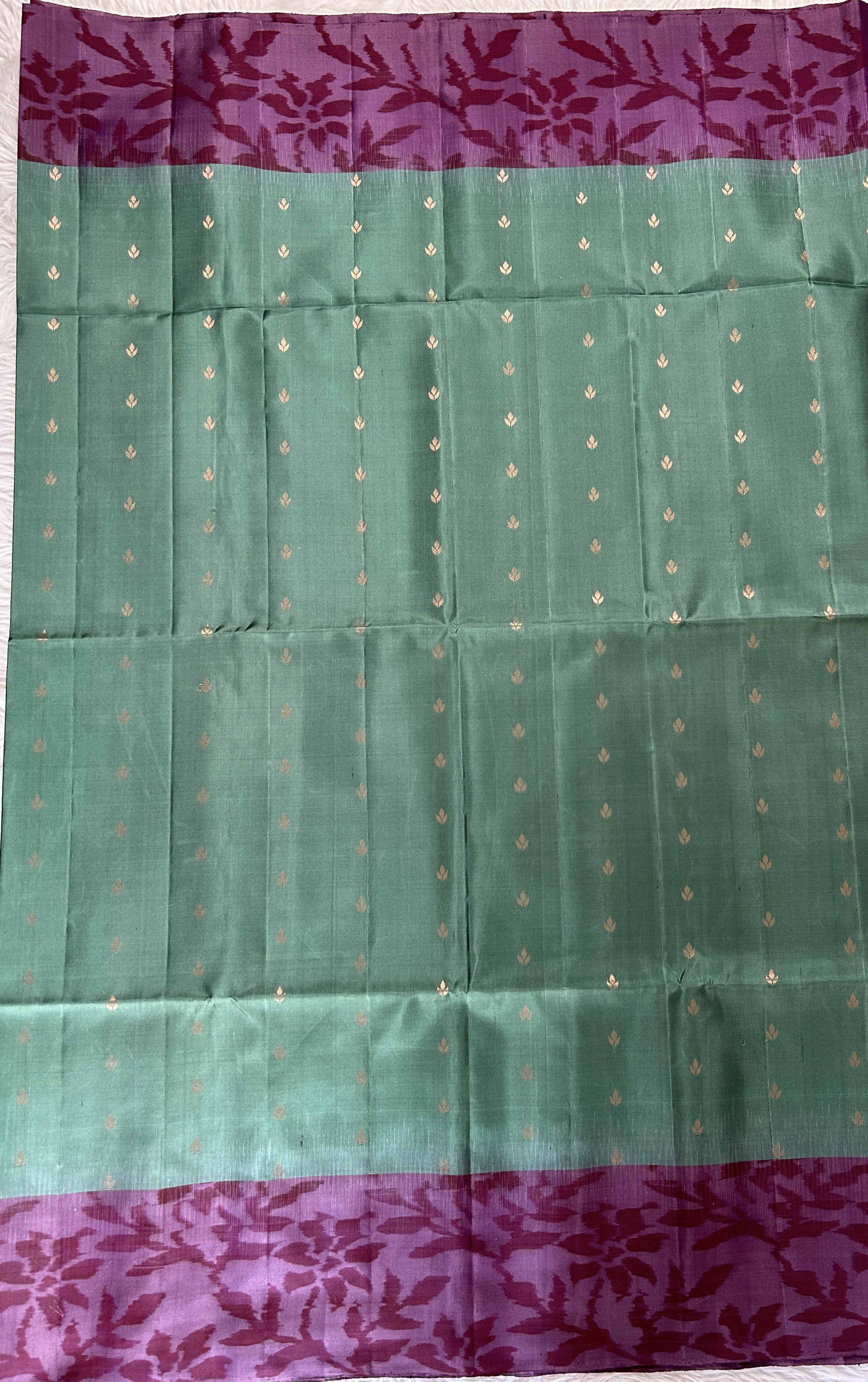 Kanjivaram Festive Soft Silk Saree Bottle Green colored Saree complemented with a Violet Colored Pochampally border. - Sampradaya Designer Studio