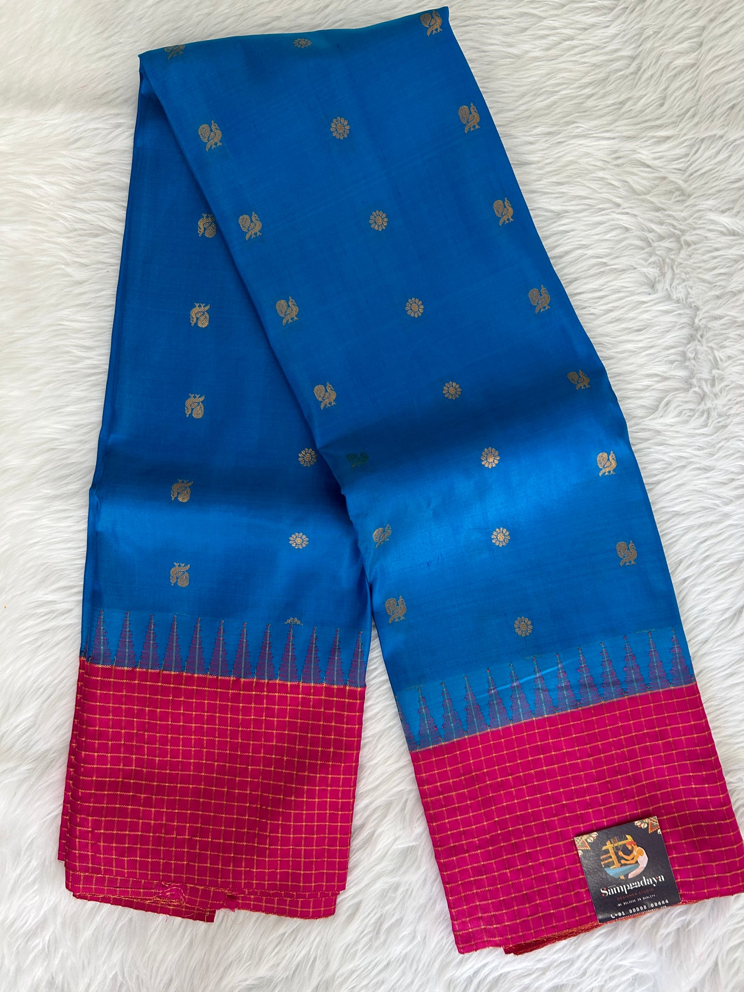 Gadwal Pattu Saree Rama Blue colored saree complemented with a Pink Kanchi border - Sampradaya Designer Studio