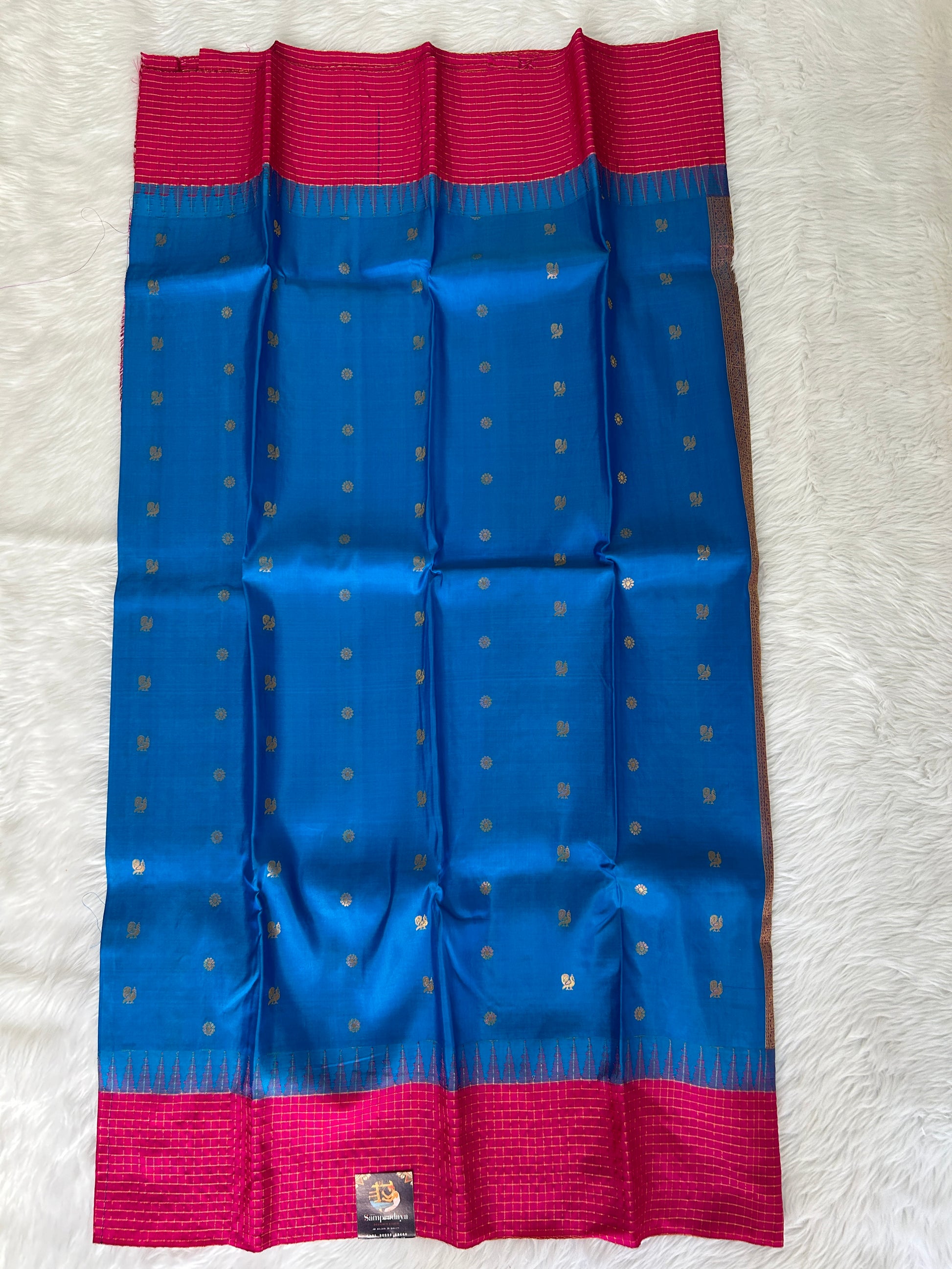 Gadwal Pattu Saree Rama Blue colored saree complemented with a Pink Kanchi border - Sampradaya Designer Studio